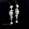Pendientes largos, a la moda y elegantes, con circonita microincrustada y diseño de vid con borla, un accesorio estiloso para el atuendo formal de mujer, fabricado por la fábrica