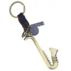 Joias Transfronteiriças Modernas e Populares Pingente Criativo de Liga Metálica de Instrumento Musical Chaveiro Decorativo Acessórios de Couro Trançado Ornamento Pendente