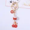 Nuevo llavero de gato de la suerte de cerámica roja con texto de bendición, pequeño accesorio de aleación, decoración para bolso, pequeño regalo al por mayor