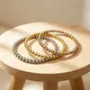Moda INS europea y americana simple y moderna joyería de mano, pulsera de cuentas de acero inoxidable de lujo ligero, chapado en oro de 18 quilates, 6 mm