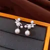 Pendientes de borla con flor de trébol de circonita vintage con un toque de alta gama, pendientes versátiles y de moda al por mayor