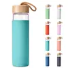 Botella de Vidrio Borosilicato de Grado Alimenticio Más Vendida en Amazon Diámetro Grande Tapa de Bambú Vaso Portátil para Beber con Funda de Silicona de Colores