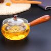 Tetera de vidrio de borosilicato alto al por mayor para el hogar, tetera lateral de madera hecha a mano para hervir, tetera lateral de flores hecha a mano para estufa de cerámica eléctrica