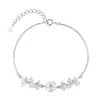 Pulsera de plata de ley S999 flor de glicinia dulce pulsera de flor de circón redondo joyería de lujo ligero viento frío al por mayor mujer