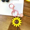 Llavero de girasol transfronterizo, llavero de cara sonriente, lindo accesorio para bolsa, decoración colgante al por mayor, colgante de girasol