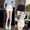 Falda corta negra para mujer 2026 nueva primavera y verano cintura alta petite hot girl abertura línea A de un paso que cubre la cadera pantalones falda