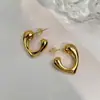 Diseño de nicho, estilo minimalista, aretes en forma de corazón, aretes geométricos huecos de alta gama, aretes de argolla pequeños modernos y únicos para mujer