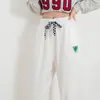 Calça Casual Nova Primavera e Outono Feminina Versátil Solta com Barra Afunilada Elementos de Abelhas Pequenas e Xadrez Calça Esportiva Atacado