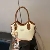 Bolso de mano de nicho para mujer, nuevo modelo de primavera 2026, con bloques de color, moderno y a la moda, sensación de alta gama, bolso tipo cubo de un solo hombro cruzado