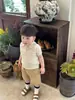 Ropa infantil coreana 2026 verano nuevo estilo niños moderno y genial seda de hielo tejido hueco manga corta conjunto casual de pantalones cortos