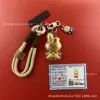 Llavero de tela con logo de empresa personalizado Cadena para teléfono móvil Angela Lámina de oro puro Oro 999 Regalo de aniversario