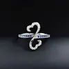 Anillo de Cobre con Cruz de Mariposa Hueca Simple de Línea Cruzada y Circonita Moda Anillo R7864