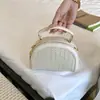 Bolso tejido de lujo ligero de estilo coreano de nicho para mujer, bolso casual tipo concha para el verano 2026, bolso de hombro y cruzado de alta gama