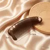 Peine de madera maciza de sándalo negro y dorado, con diseños pintados tridimensionales, un peine de dientes finos y engrosado para uso doméstico, diseñado para masajear y alisar el cabello.
