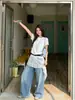 Tiroteo real estilo coreano camiseta de dos piezas falsas de encaje empalmado para mujer 2026 nuevo top corto irregular con cinturón 14037