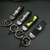 Llavero de coche con patrón de dibujos animados de marca creativa y moderna, colgante para motocicleta, correa de cuero y metal anti-pérdida, regalo