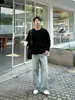 Top de punto cálido suelto para hombre con cuello Henley negro para otoño, capa interior, tacto de alta gama, nuevo estilo 2026