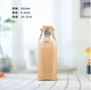 Botella de vidrio cónica para bebidas al por mayor corcho botella de té frío suministro botella de jugo transparente botella de jugo de enzimas imprimible