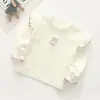 Ropa de Primavera y Otoño para Niños Camiseta para Niñas Bebé Elegante Personalidad Infantil Marca de Moda Estilo Coreano Bordado de Dibujos Animados Volante Encaje Camiseta Base