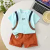 Traje de Dos Piezas Casual de Verano 2025 Nuevo para Niños, Bolsa Escolar Redonda con Estampado de Dibujos Animados, Manga Corta, Moderno