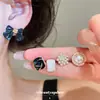 Conjunto de pendientes de perlas con lazo de color caramelo elegante estilo coreano para mujer, pendientes dulces con un diseño moderno y único
