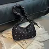 Bolsa de Ombro Popular em Formato de Dumpling deste Ano para Mulheres 2025 Nova Bolsa de Ombro com Laço e Bolinhas Estilo Ocidental Bolsa de Mão para o Dia a Dia