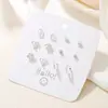 Set de pendientes de nicho de venta caliente transfronterizo de una semana con aleación de diamante de garra de alta gama, corazón y flor, pendientes de dopamina al por mayor