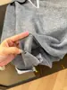 ¡SOL! Camisa de retazos gris con cuello polo, suéter de dos piezas falso para mujer, tejido elegante de otoño 2026 para commuting