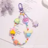 Nuevo Colgante de Llavero Acrílico con Recubrimiento de Color de Doble Cara con Forma de M Cadena de Perlas Estilo Dopamina Accesorios para Funda de Auriculares