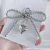 Estilo Coreano Ins Nuevo Chica Dulce Lazo de Perlas Colgante Corazón Plateado Llavero Colgante Auriculares Bluetooth Colgante