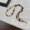 Collar largo de cuentas de ojo de tigre marrón de Maillard, moda de otoño e invierno, elegante cadena de lana de celebridades de Internet de moda para mujeres