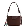 Bolso de hombro vintage de gamuza modelo nuevo 2026, bolso cruzado versátil de nicho para el día a día con correa de hombro de cuerda trenzada, bolso de axila con sensación de alta gama