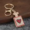 Chaveiro de garrafa de perfume cravejado de diamantes, pingente de garrafa de perfume com strass em formato de coração, acessório de bolsa moderno, chaveiro presente atacado