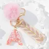 Suministra y Vende Llaveros con Alfabeto de 26 Letras con Lentejuelas Moradas, Llaveros de Pompones de Mariposa, Dijes para Bolsos de Mujer