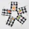 Bolsa de algodón con cordón de Navidad al por mayor bolsa de almacenamiento de dulces y regalos Bolsa de algodón con diseño de pingüino a cuadros navideños personalización
