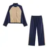 Conjunto de roupas esportivas femininas de outono novo para cross-border: jaqueta curta color block com gola alta + calça longa reta color block lateral