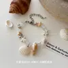 Pulsera trenzada de conchas estilo resort costero bohemio, ajustable con cordón, pequeña, fresca, de moda, de alta gama