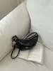 Bolso tipo bolsa de dumplings coreano transfronterizo súper popular para mujer, nuevo bolso de hombro vintage 2026, bolso cruzado de moda, bolso de cuerno