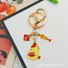 Llavero Colgante Año Nuevo 2026 Metal Zodiaco León Dorado Petardo Despertar Bolsa de la Fortuna Colgante Evento Pequeño Regalo