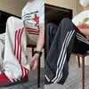 Pantalones deportivos de retazos a rayas estilo retro americano de seda helada de secado rápido, pantalones rectos holgados de moda de alta costura, pantalones casuales para adolescentes