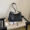 Bolso tejido de nicho súper popular para mujer, nuevo modelo 2026, versátil para el trabajo, bolso de hombro y cruzado, bolso tipo cubo de moda de alta gama
