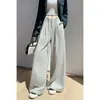 Foto real de traje de mujer de alta gama con caída, pantalones de pierna ancha, colección otoño 2026, con diseño de cintura de corbata, tiro alto, adelgazante, pierna recta, pantalones hasta el suelo