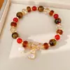 Pulsera de cuentas de ojo de tigre, sensación de lujo ligero de nicho de alta gama, accesorio de mano versátil estilo Maillard