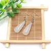 Venta al por mayor de fábrica aretes largos de cristal natural forma de gota de agua amatista Ojo de Tigre Joyería con gancho para la oreja aretes redondos de gota de agua DIY