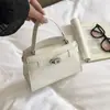 Bolso de mano con cierre de broche de temperamento estilo extranjero para mujer 2026 otoño nuevo bolso de mano con patrón de cocodrilo bolso de hombro de moda versátil para el trabajo bolso pequeño