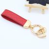 Llavero de coche de moda para pareja, hombre y mujer, con diamante en relieve, creativo, de cuero, con cuerda, para bolso, llavero, colgante, pequeño regalo
