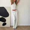 Conjunto de pantalón largo de pierna ancha y caída con cintura elástica y chaleco de terciopelo, con top ajustado sin mangas y cuello alto para un look elegante y con estilo.