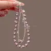Colgante de Perla de Cristal Suave y Elegante Cadena para Teléfono Móvil Llavero de Nudo de Lazo Estrella de Cinco Puntas Cadena Doble Accesorios Modelo Nuevo 2026