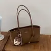 Bolso de hombro, bolso de axila, bolso tote para el día a día, diseño de nicho retro de alta gama transfronterizo, nueva moda 2026