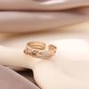 Europa y Estados Unidos venta caliente transfronteriza joyería moda viento simple micro incrustación forma de nudo abierto anillo de circón dorado para mujer